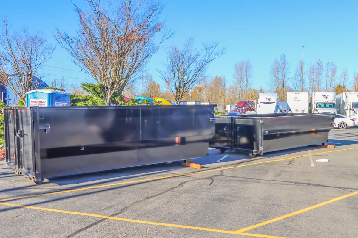 Professional dumpster rental service with roll-off container on residential driveway in Buenaventura Lakes